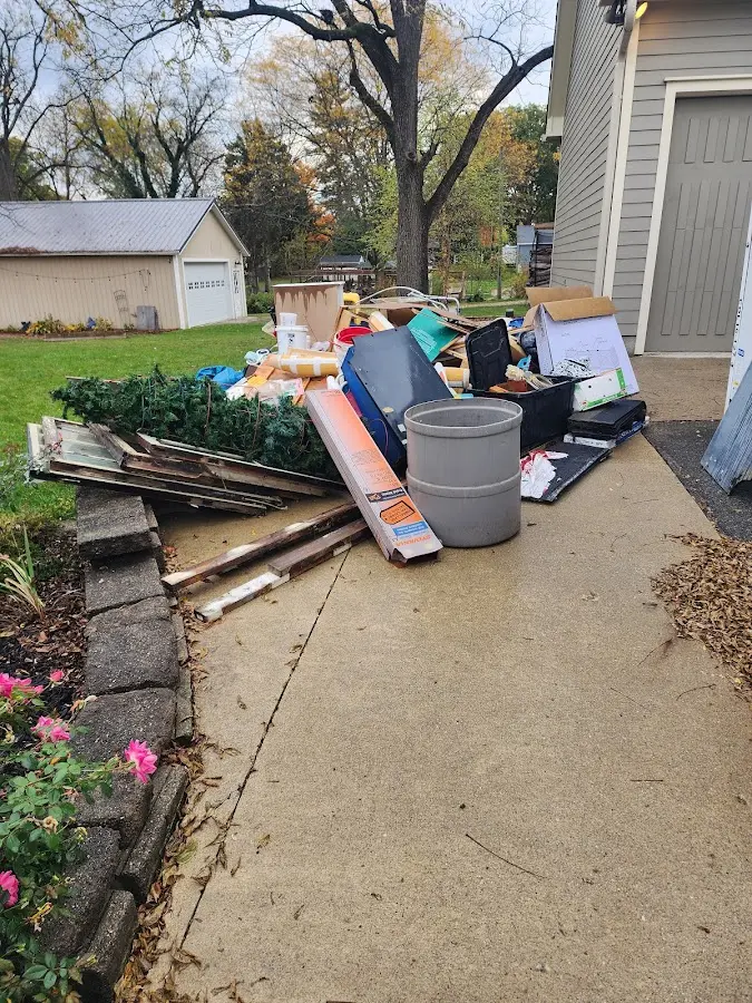 Dumpster being loaded with debris for Roofing Dumpster Rental in Harvey
